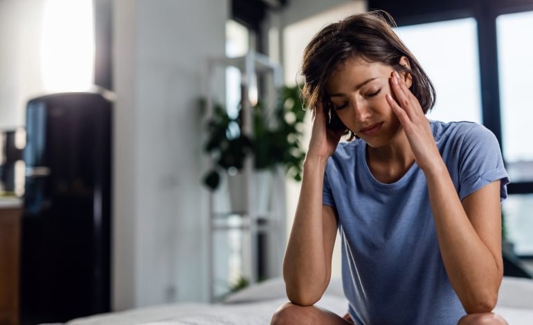 A woman feeling stressed and overwhelmed