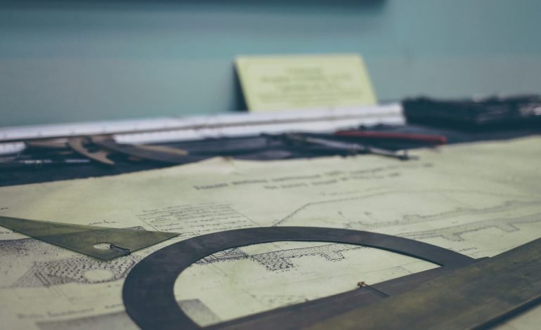 Planning permission documents and architectural plans on a desk