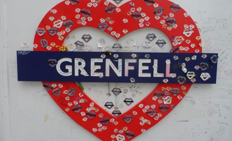 Full Council meeting discussing Grenfell safety progress with a heartfelt Grenfell memorial in the background.
