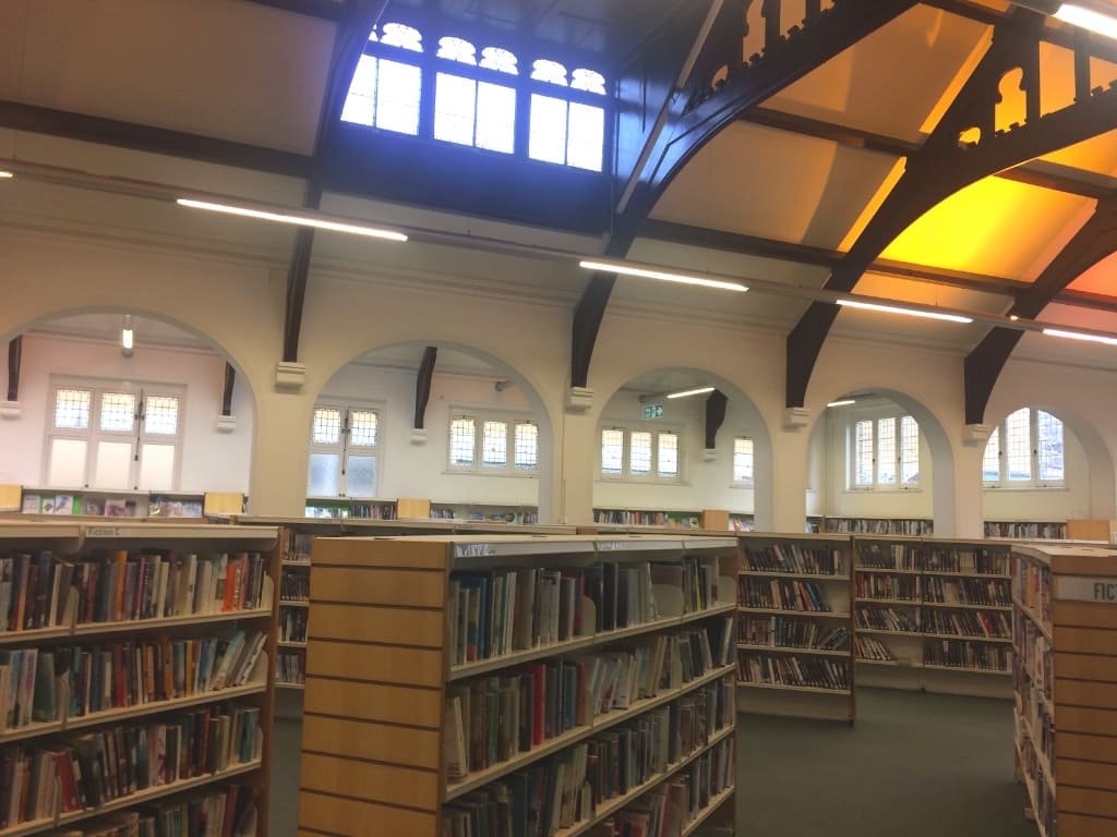 A view Inside Putney library, including bookshelves at the bottom, and its impressive 19 century wood-vaulted ceiling above.