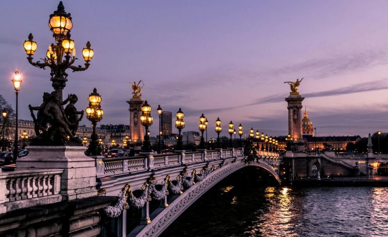 The Summer Olympics 2024 opened with a breathtaking ceremony on the Seine River in Paris, showcasing the city's iconic landmarks illuminated under the evening sky