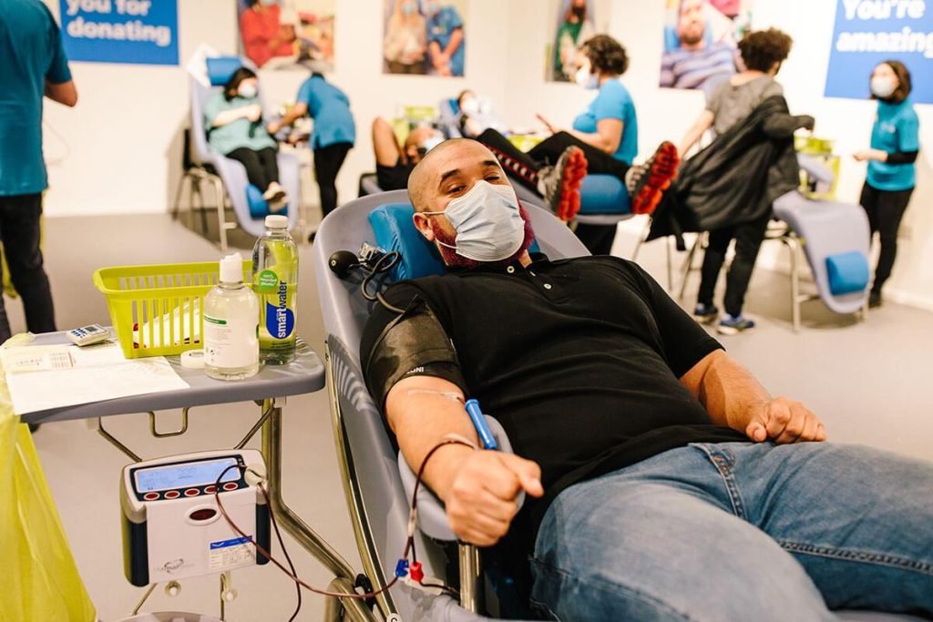 A man giving blood in White City. Urgent Appeal for Blood Donors Following Recent Tech Issues