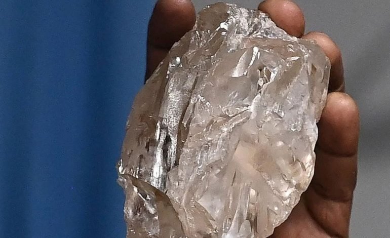Close up of the second largest diamond ever found, discovered in Botswana, held in hand, showcasing its immense size and clarity