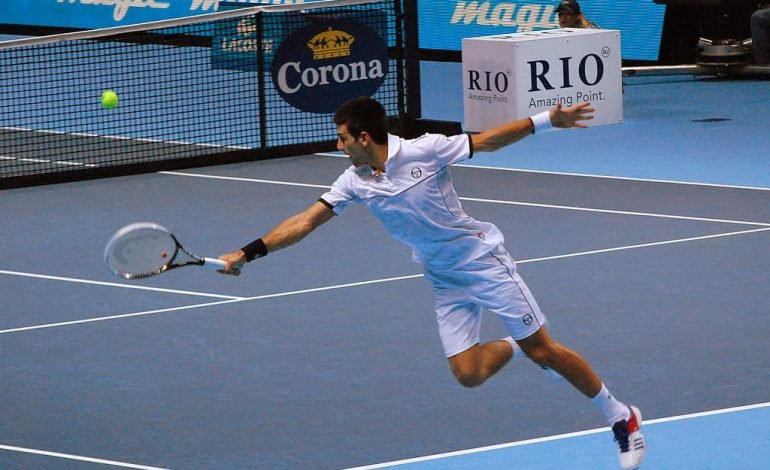 Djokovic’s U.S. Open exit as he stretches for a shot during a match, highlighting the intense moments that defined his unexpected defeat to Popyrin