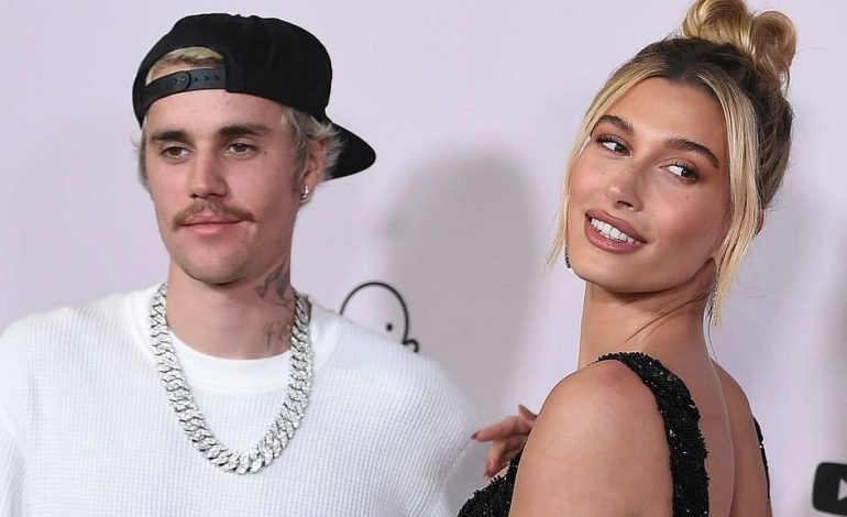 Justin and Hailey Bieber at an event, celebrating the arrival of their first child, Jack Blues Bieber.