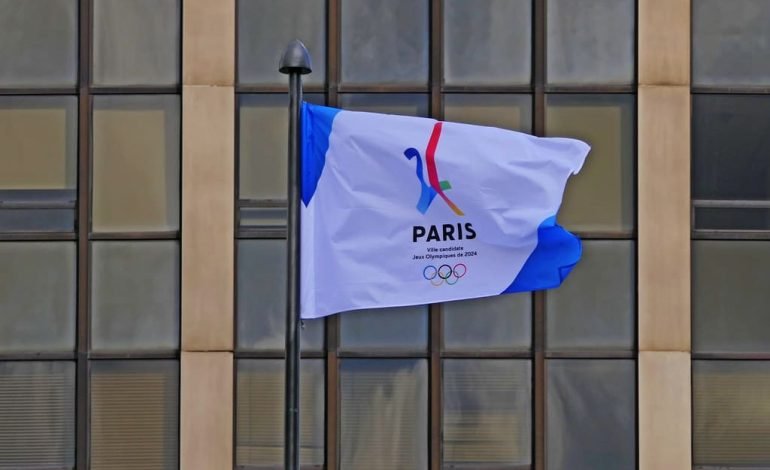 Team GB athletes celebrating on the podium at the Paris 2024 Olympics.