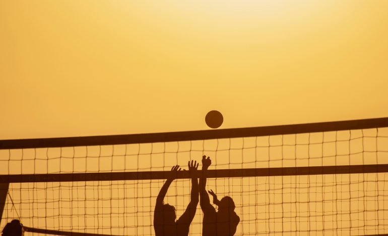 Peter Spens paints the beach volleyball at the Paris Olympics.