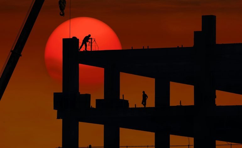 Construction site with foundational work being started at sunset, representing property development.