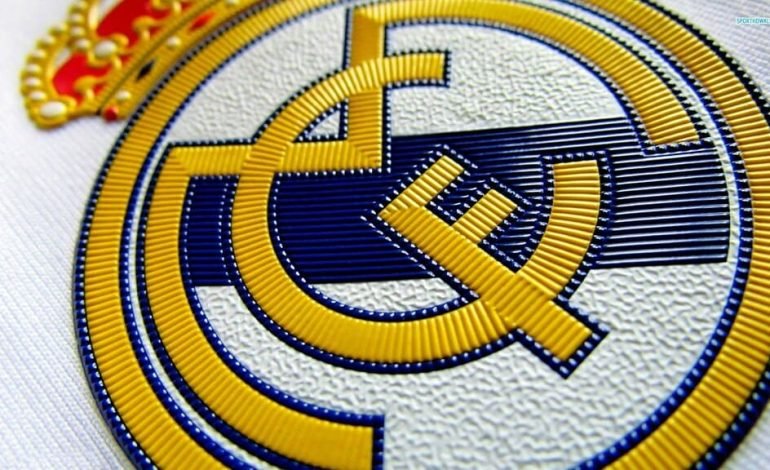 Close-up of the Real Madrid football club crest, with Carlo Ancelotti's legacy intertwined in the club's emblematic history.