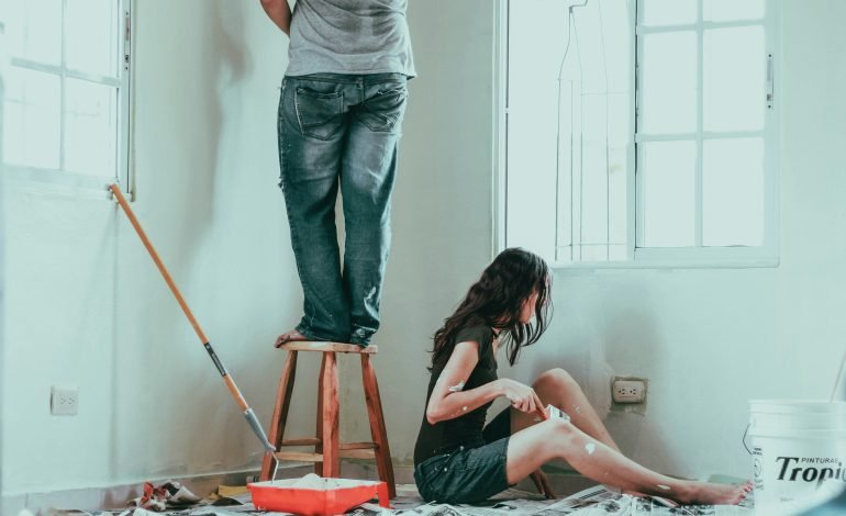 Couple renovating their home amid falling mortgage rates, highlighting the impact of reduced interest rates on homeowners' decisions.