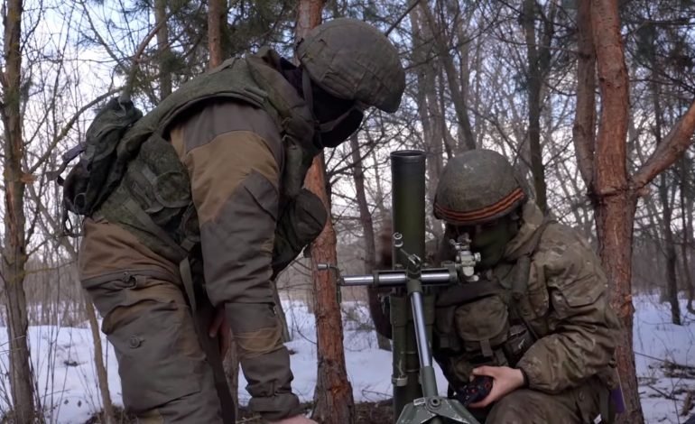 Russian volunteer soldiers operating a mortar in northeastern Ukraine during the 2023 conflict, highlighting military tactics and involvement.