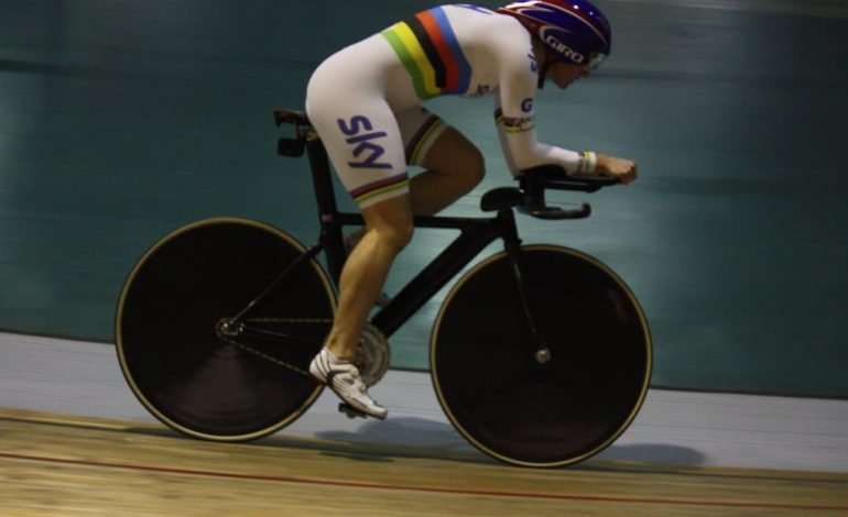 Sarah Storey competing in a cycling time trial, showcasing her determination at the Paris Paralympics 2024.