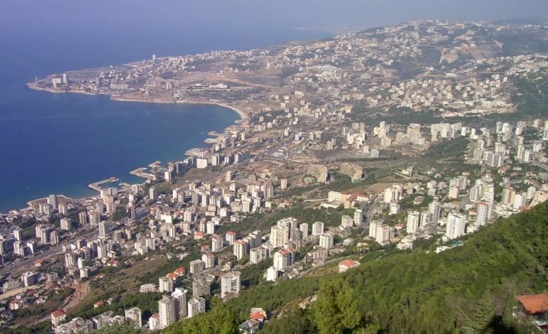 UK advises British nationals to leave Lebanon as view of city coastline shows peaceful yet tense atmosphere.