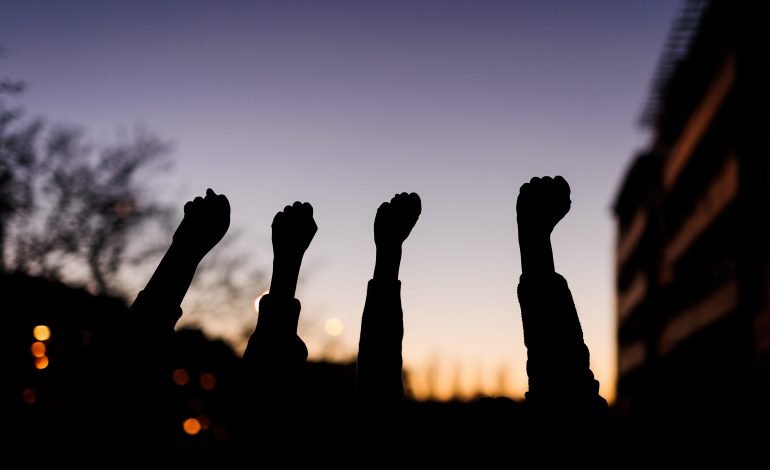 Women defy Iran’s hijab laws, raising fists in solidarity and resistance, symbolising the ongoing fight for freedom and rights.