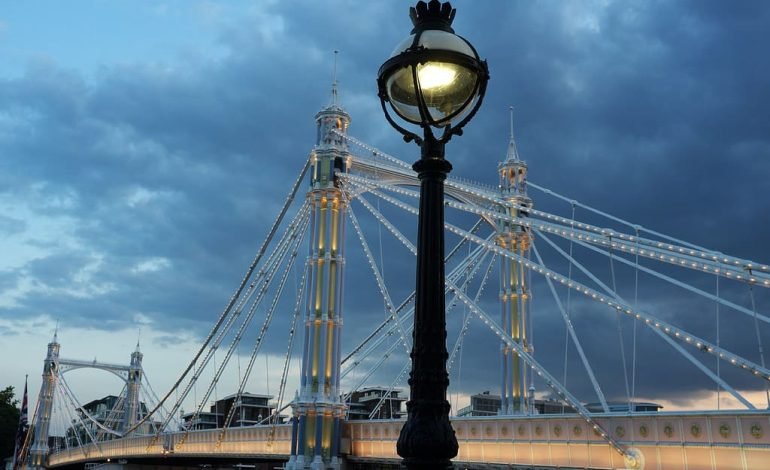 Albert Bridge closure at dusk with lights illuminating the structure against a cloudy sky
