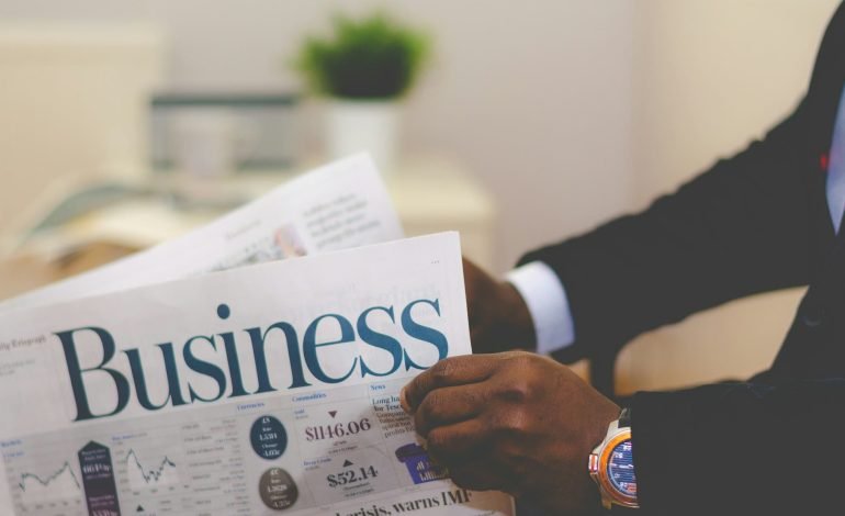 Dean Forbes reading a business newspaper after topping the Black Powerlist 2025