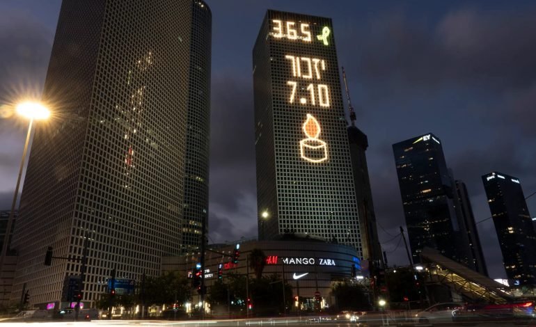 Tel Aviv buildings illuminated with memorial symbols for the one year anniversary of the 7th October Hamas attack, Israel, 365 days remembrance candle.