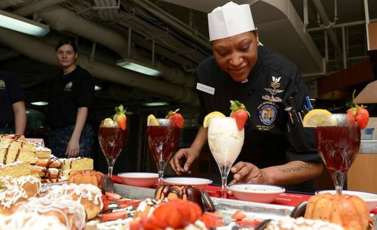 A chef arranging beautifully decorated desserts, reminiscent of the creativity showcased on The Great British Baking Show.