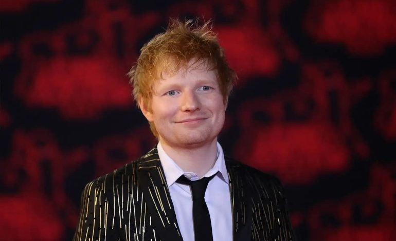Ed Sheeran, featured in the Band Aid song controversy, photographed at a public event.