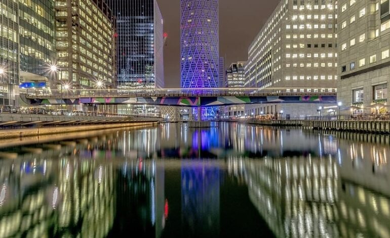 Canary Wharf Winter Lights Festival showcasing vibrant light installations reflected in the water.