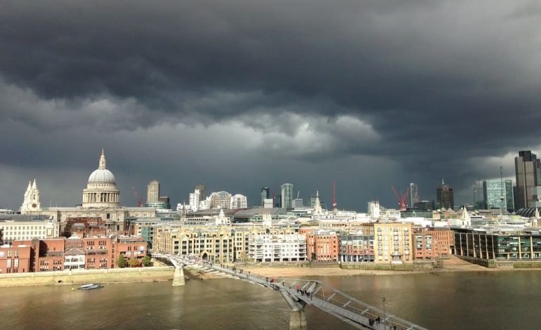 London faces stormy weather with clouds over Millennium Bridge and St. Paul’s Cathedral, reflecting 50mph gusts on New Year’s Day.