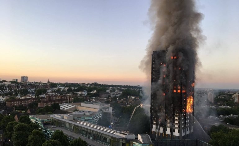 Grenfell Tower engulfed in flames with thick black smoke rising into the sky, as firefighters battle the fire in North Kensington, London.