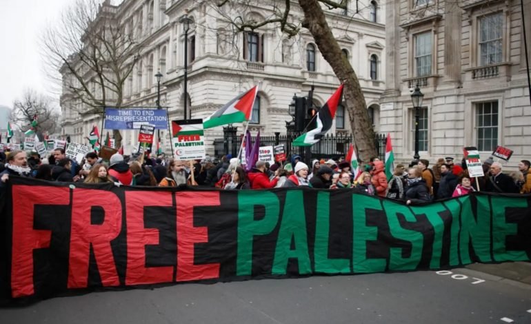 Crowds gather with flags and banners during London protest weekend march in central London