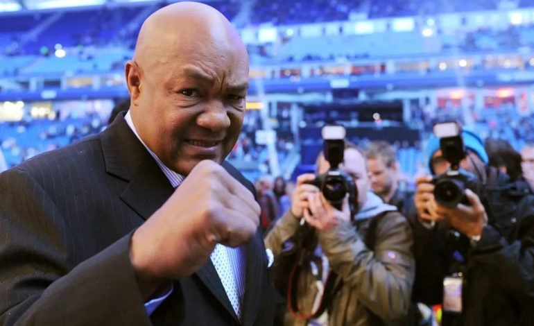 George Foreman at a public event surrounded by photographers – tribute to the boxing legend