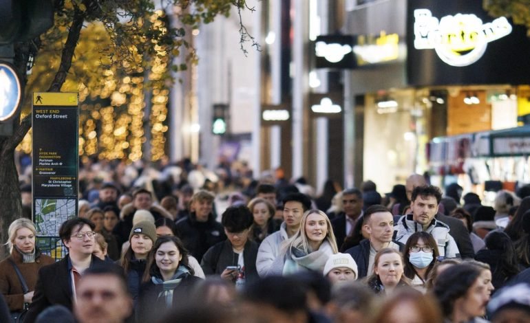 Oxford Street's bustling crowds during an evening in London, showcasing the city's vibrant shopping district.