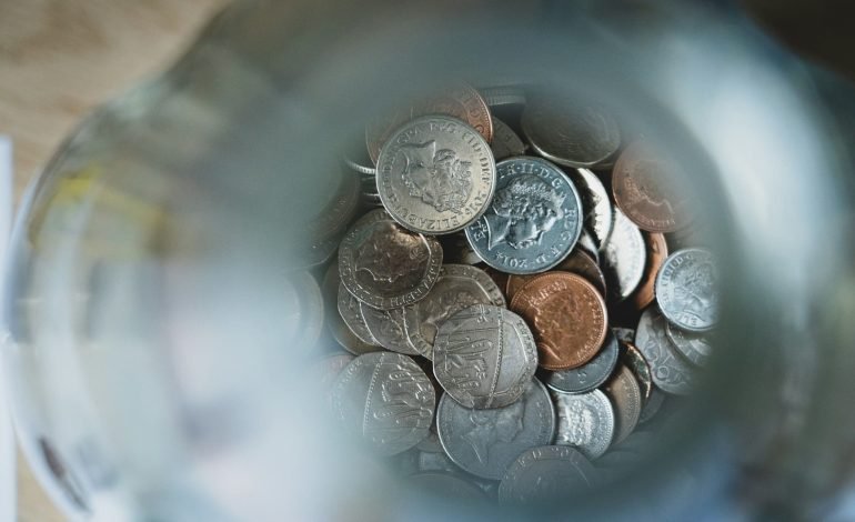 British coins in a jar article on money advice roadshow