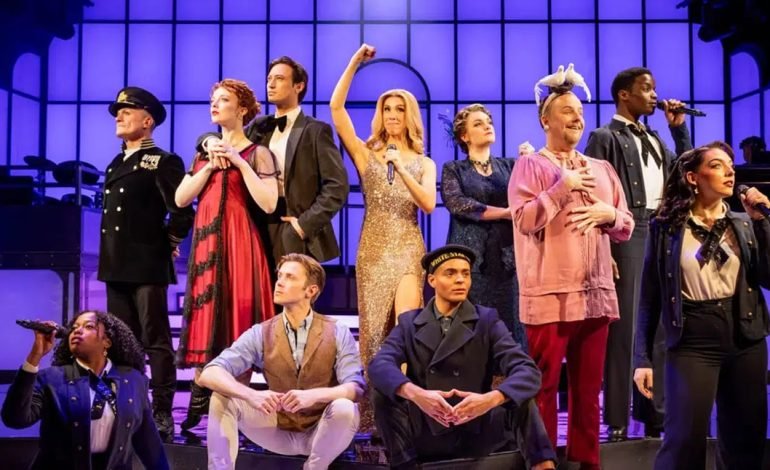 Cast of Titanique musical on stage in costume at the Criterion Theatre with Celine Dion character centre stage, under purple lighting.