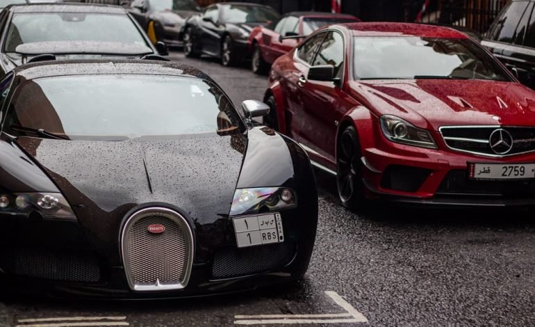 Luxury cars parked on a London street, symbolising how the UK loses millionaires over time