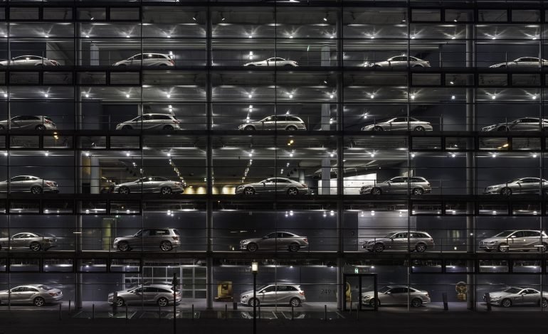 Mercedes Benz dealership at night representing global auto industry impacted by Trump trade tariffs