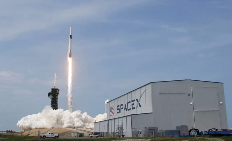 Rocket launch beside a SpaceX facility highlighting Elon Musk's Texas expansion and industrial growth in Bastrop County