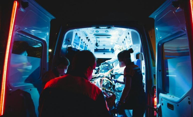 paramedics loading patient on to ambulance