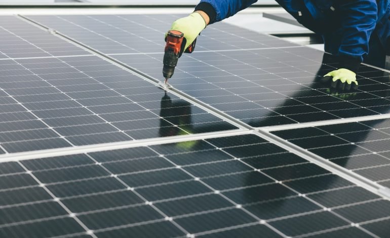 worker installing solar panels