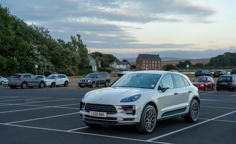 a white porshe suv in a car park for npp article