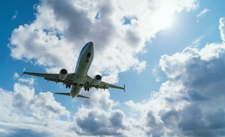 airplane flying underneath clouds for fuel cell article