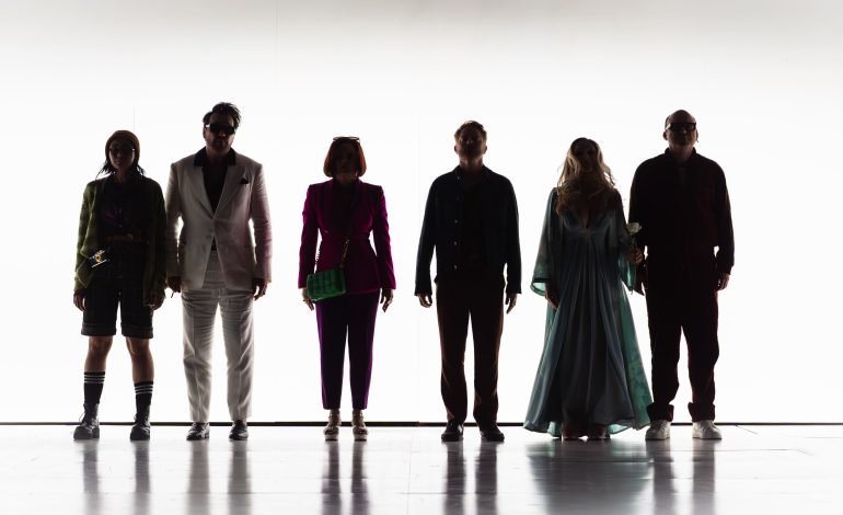 Cast of Here We Are Sondheim musical at the National Theatre, silhouetted on stage in Joe Mantello’s surreal production