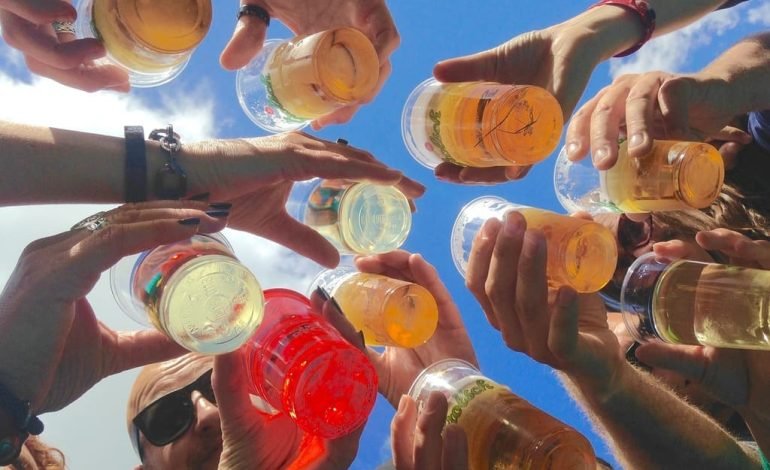 Group of people raising glasses of beer towards the sky at City Beerfest 2025 in London’s Guildhall Yard