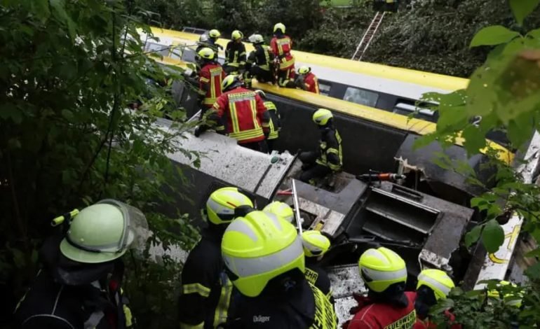 Emergency services at scene of train derailment in Germany with overturned carriage