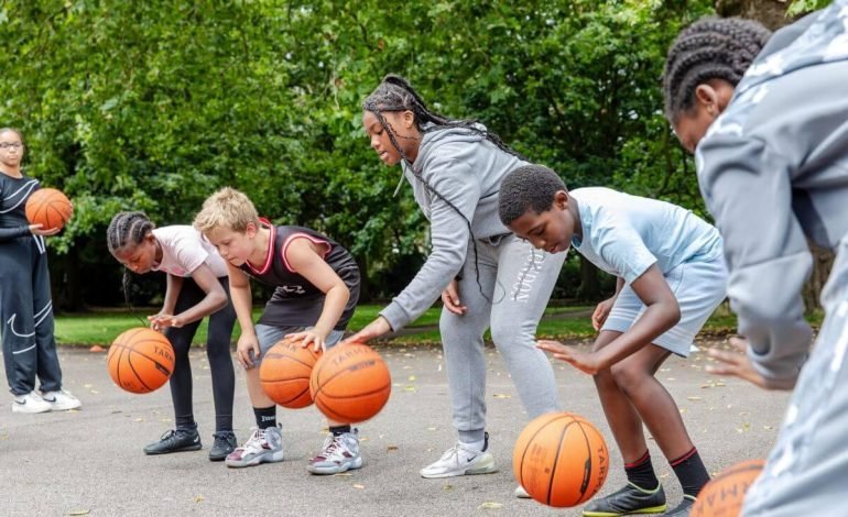kids playing basketball at summer in the city 2023