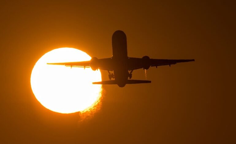 Airplane taking off at sunrise, representing rising costs and UK inflation pressures on travel and economy