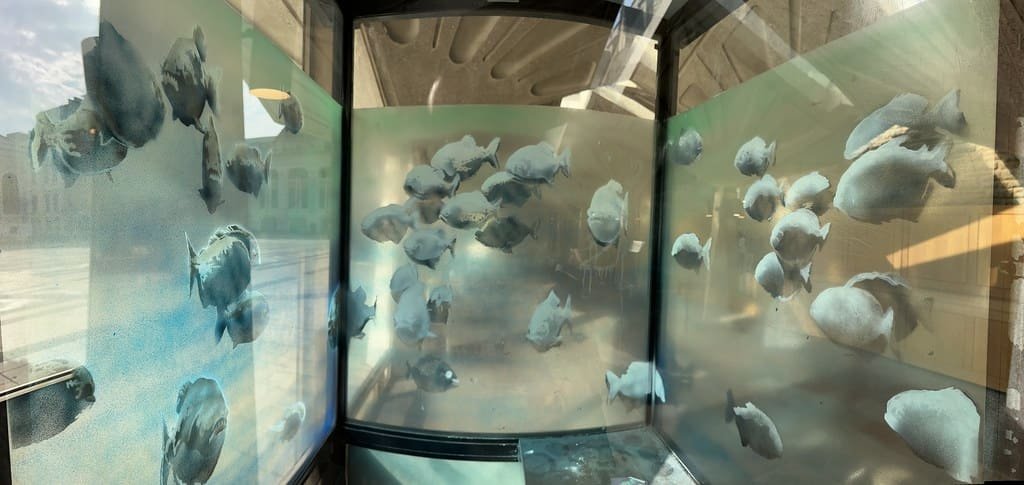 Banksy's Piranhas moved to London Museum interior of spray painted City sentry box with a shoal of piranhas
