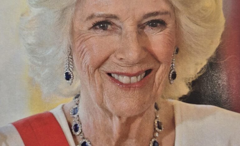 Queen Camilla wearing tiara, sapphire necklace and King Charles III miniature portrait Family Order at state banquet