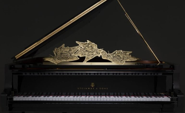 Steinway grand piano with gold leaf design in London showroom