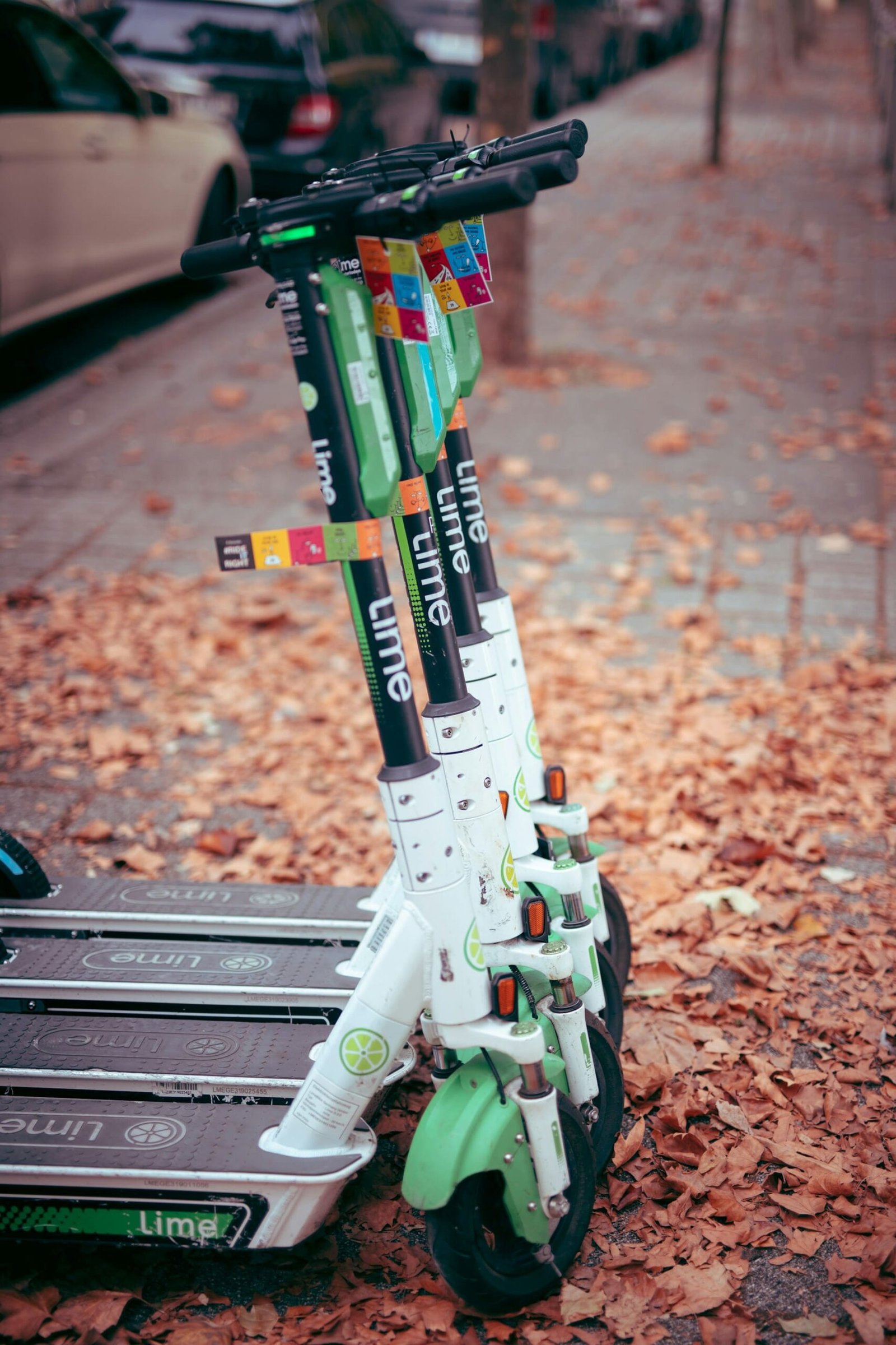 lime e scooters parked on the pavement