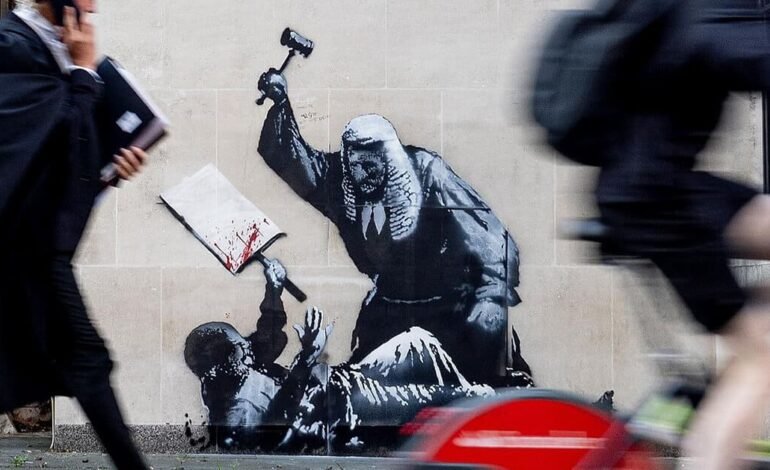 Banksy mural at the Royal Courts of Justice on Carey Street, London – judge striking protester stencil