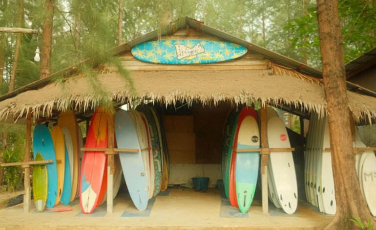 surfers surf boards in a hut