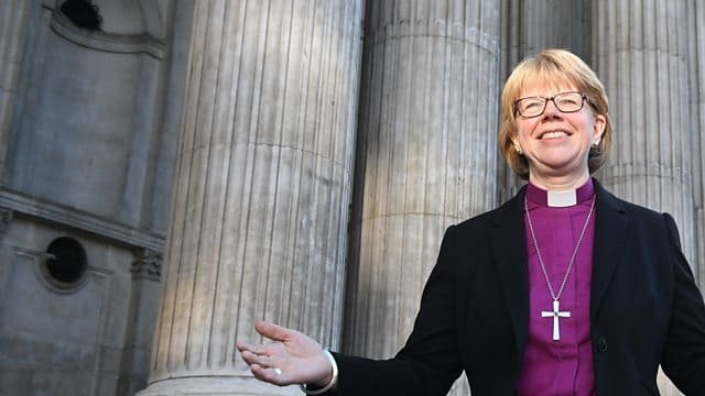 First female Archbishop of Canterbury Sarah Mullally outside a cathedral